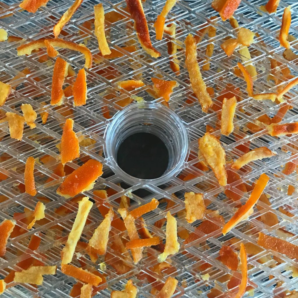 Dehydrating candied orange peel. The peel would otherwise have been thrown away